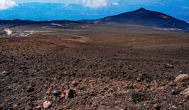 The view of the Etna volcano peak with blue sky 