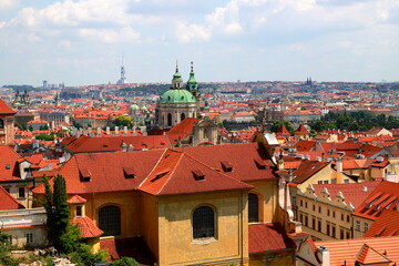 Prague, Czech Republic. Mala Strana of Prague. Top view of downtown, panorama. Ancient medieval buildings with red tiled roofs, church, tower, castle