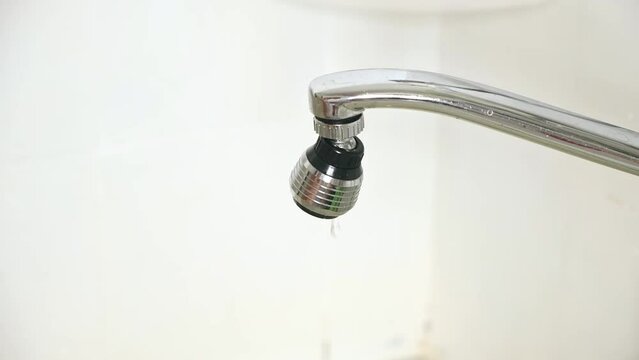 Running and dripping water. Turning off the water. Water tap , faucet. Flow water in bathroom with sink. Hygiene concept.
