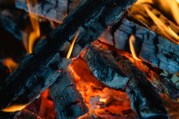 Wooden logs are burning in the fireplace. close-up.