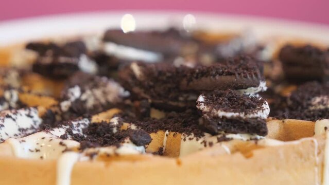 A close up view of waffles with Oreo cookie sprinkles.