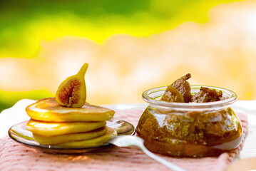Fig jam and pancakes on table, summer