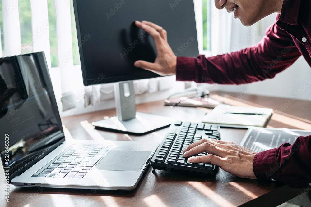 Poster asian man programmer looking and touching on screen laptop to ty
