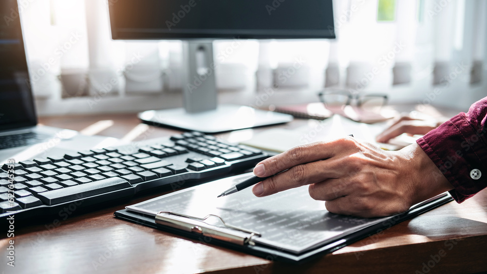 Poster close up hand of asian man programmer holding pen to writing cod