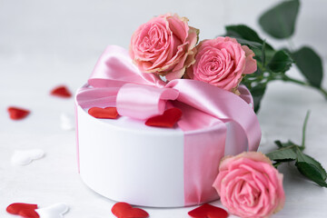 Beautiful surprise greeting for saint Valentine's or Women's Day, birthday or Anniversary for beloved. Fresh pink roses, gift box with sweets. White background. Holiday atmosphere - Powered by Adobe