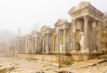 Partially reconstructed Nymphaeum building at ruins of ancient city of Sagalassos on foggy winter...