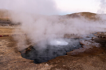 Fototapeta na wymiar Exploring the fascinating geothermic fields of El Tatio with its steaming geysers and hot pools high up in the Atacama desert in Chile, South America 