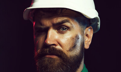 Closeup portrait of mechanical worker in hardhat. Industrial worker in in safety helmet....