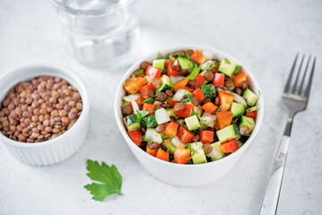 Lentil red bell pepper cucumber salad in a bowl