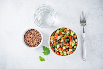 Lentil red bell pepper cucumber salad in a bowl