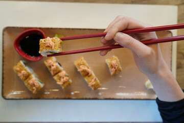 woman eating sushi at Japanese restaurant