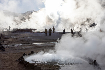 Obraz na płótnie Canvas Exploring the fascinating geothermic fields of El Tatio with its steaming geysers and hot pools high up in the Atacama desert in Chile, South America