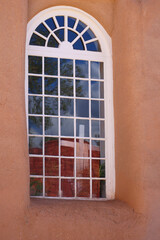 Fototapeta na wymiar Window In Church With Christian Cross Reflection, New Mexico Catholic, Adobe and Window