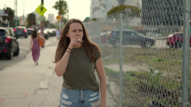 Young angry woman smoking a cigarette in extreme slow motion - Miami Florida travel photography 