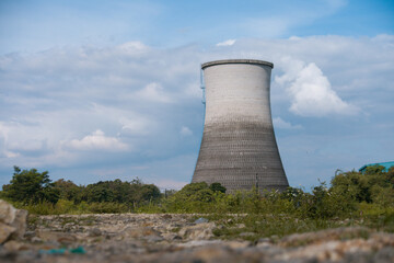 Big cooling tower in power plant with clear blue sky background