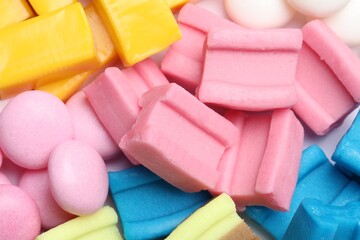 Different tasty colorful bubble gums as background, closeup