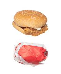 Fried Chicken Burger fly explosion, Chicken Burgers wrapped paper fall down. Hot bread chicken burger fast food throw splash in air. White background Isolated high speed shutter, freeze action