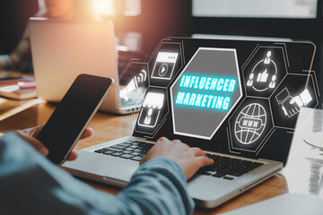Influencer marketing concept, Person working on laptop computer with Influencer marketing icon on virtual screen.