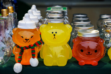Colorful drinks in the shape of a cartoon bear for sale in the store. Beverage packaging with a young, modern vibe.