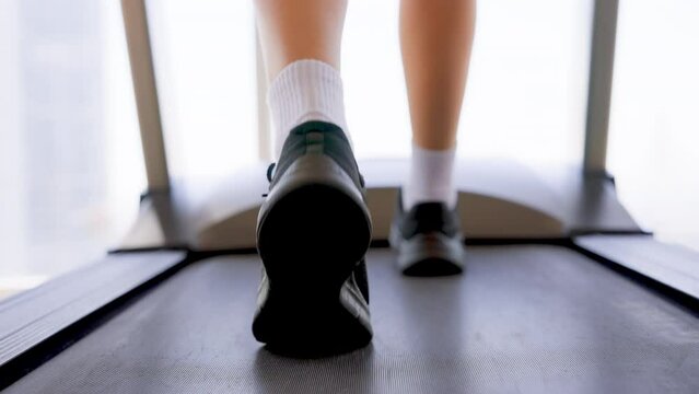 Fitness female walking on treadmill. Asian woman workout cardio and training at gym