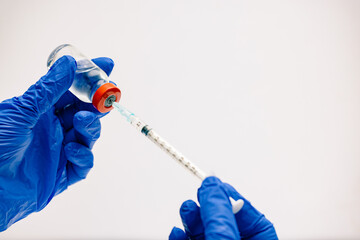 vaccine and vaccination concept 24 gauge syringe with red top vial