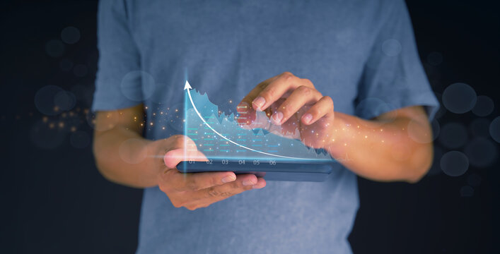 Investors use smartphones for planning and strategy, stock market, and business growth. progress or success businessman or merchant concept showing growing virtual hologram stocks invest in trading