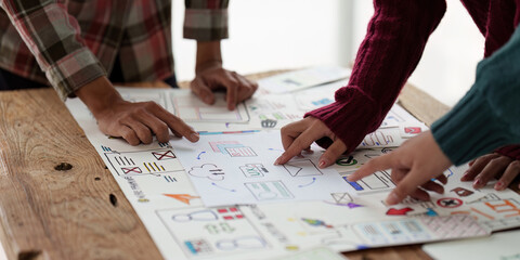 Close up ux developer and ui designer brainstorming interface wireframe design.Creative digital development agency