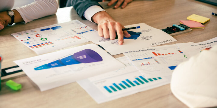 Business analyst team using laptop for financial insight with Fintech paper for data analysis dashboard. Creative and analytic brainstorming for marketing plan strategy system idea. Prodigy teamwork