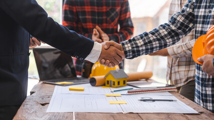 Shaking hands, Factory Meeting Room of architect engineer meeting at working desk of blueprints construction concept. Engineer people concept