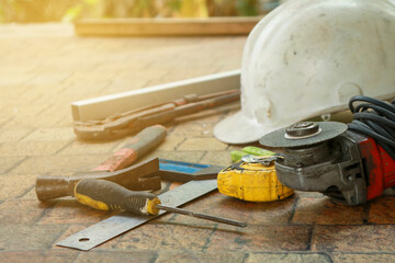 Various old hand tools lie on the table top.
