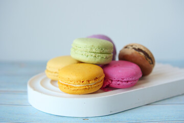 Close up of macaroon on blue background with copy space 