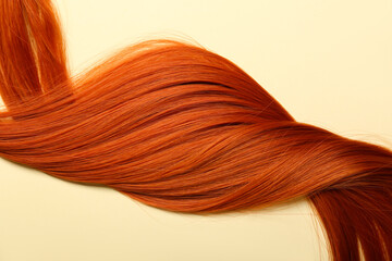 Ginger hair strand on color background, closeup