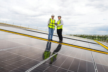 Solar panel installation, solar renewable energy installation, Asian engineer installing solar panels, electrical engineers and technicians, electricians checking solar panel system operation.