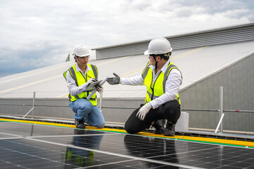 Solar panel installation, solar renewable energy installation, Asian engineer installing solar panels, electrical engineers and technicians, electricians checking solar panel system operation.