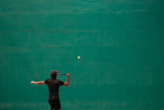 Frontenis player about to hit the ball with the racket