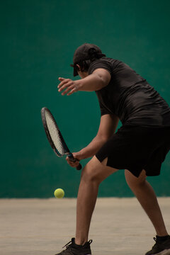 frontenis player with good technique of hitting a low short ball