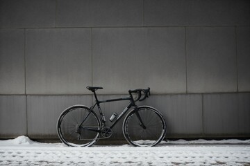 Frost-covered bicycle tire against a wall