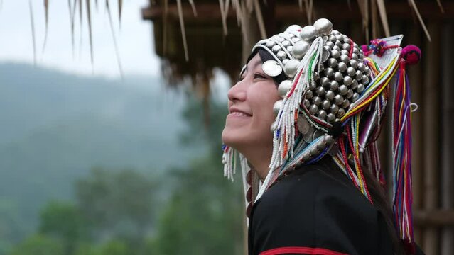 Slow motion of a young woman in Akha traditional dress looking at a beautiful nature