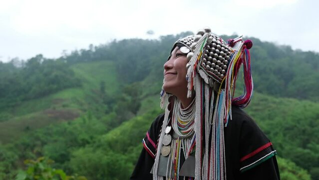 Slow motion of a young woman in Akha traditional dress looking at a beautiful nature