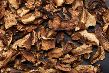 Close-up of dried porcini mushroom slices on moving platform