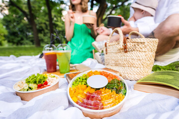 Family at a picnic with poke in the park