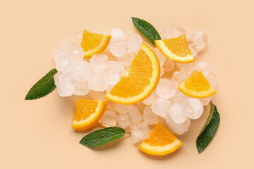 Orange slices with ice cubes and mint on color background