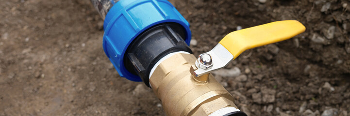Underground irrigation system with elbow fitting yellow tap or faucet