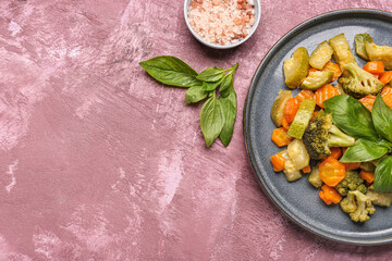 Plate with different fried vegetables on purple background
