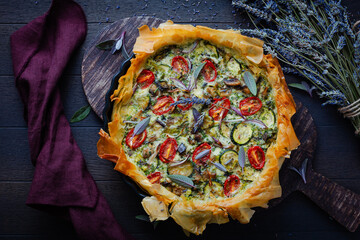 Delicious vegetarian summer quiche with zucchini, tomato, mushrooms, sage and lavender with phyllo...