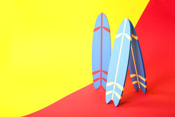 Mini surfboards on color background