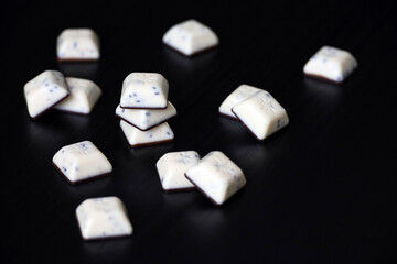 White chocolate bars, tasty dessert on dark wooden table