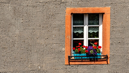 Romantic single colorfull windows on a gray building
