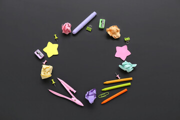 Frame made of different stationery on black chalkboard