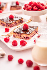 Traditional buttermilk sheet cake with raspberries and  chocolate ganache